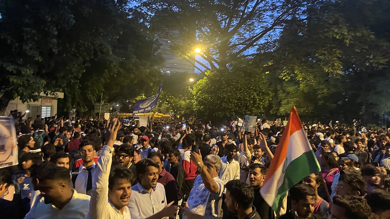 Police personnel detaining demonstrators during a protest in New Delhi